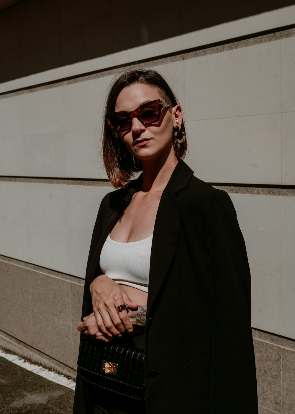 a woman in a white top and black coat