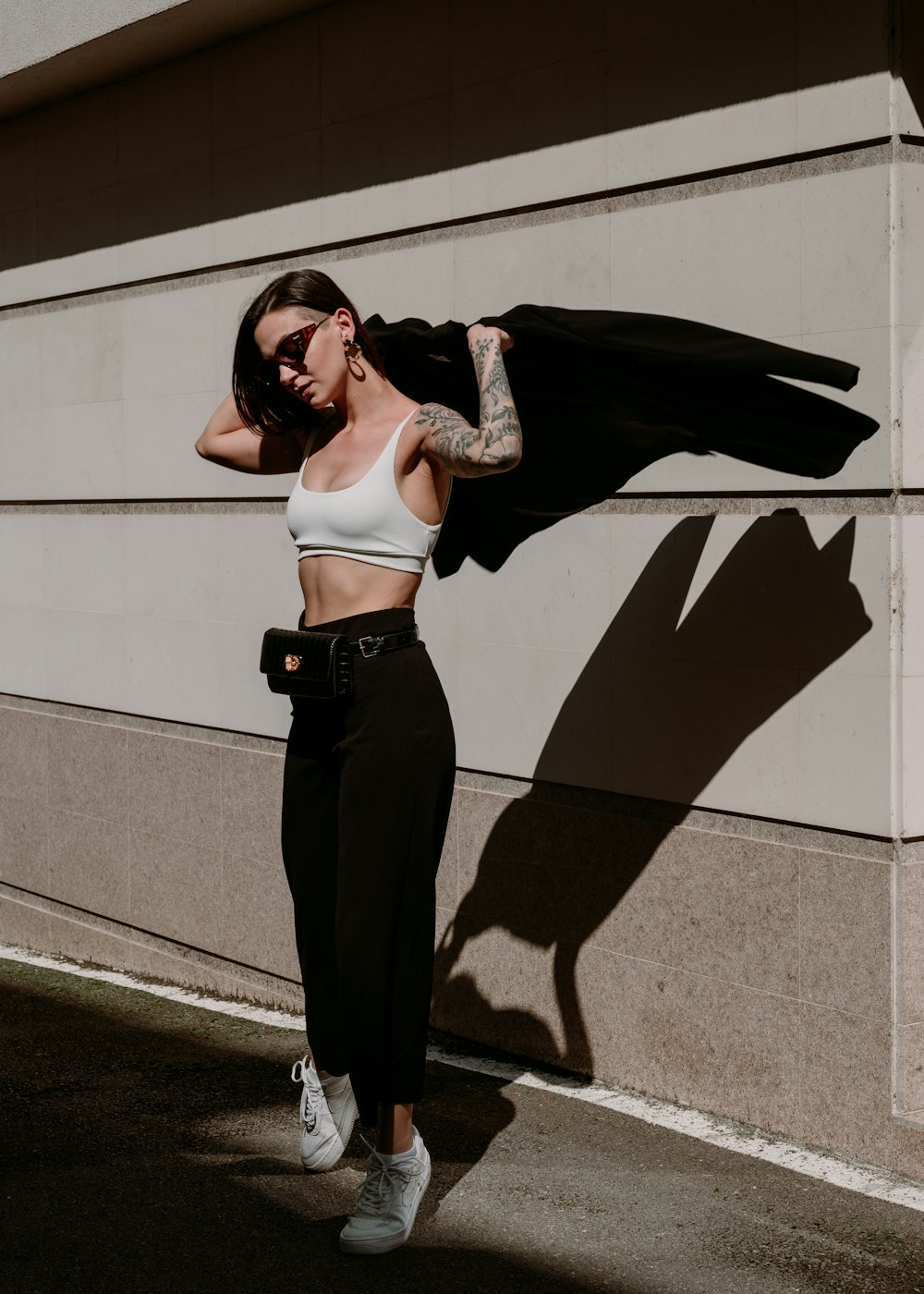 a woman in a white top and black pants