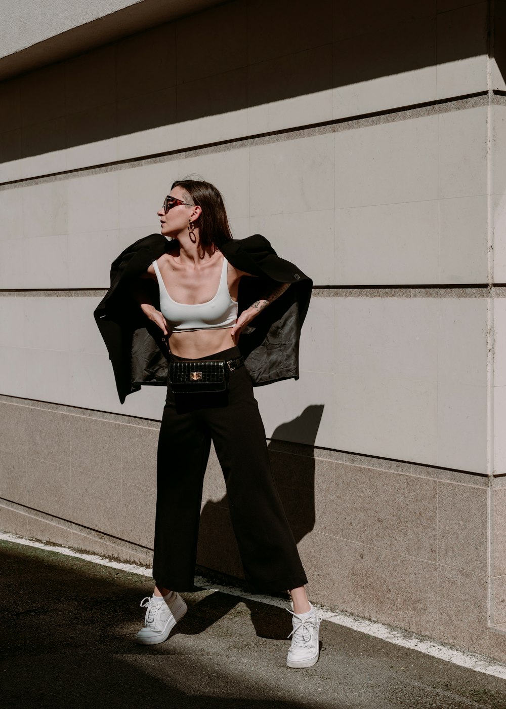 a woman in a crop top and wide legged pants