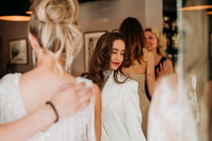 A candid shot of elegantly dressed attendees enjoying the Femdom Ball's unique atmosphere.