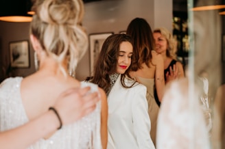 A diverse group enjoying a social event wearing elegant clothing.