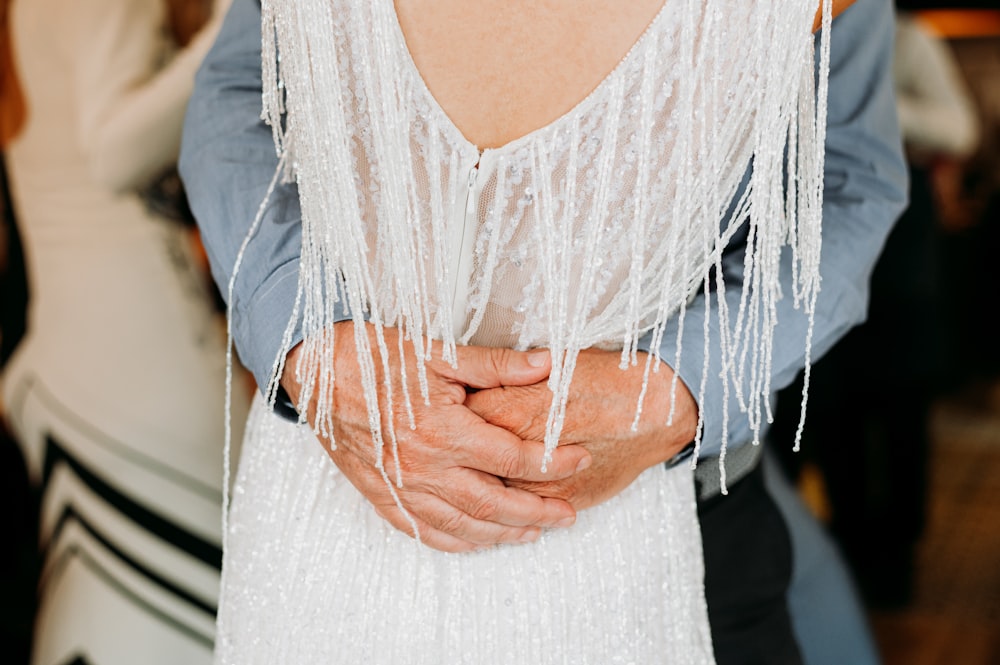 a close up of a person wearing a white dress