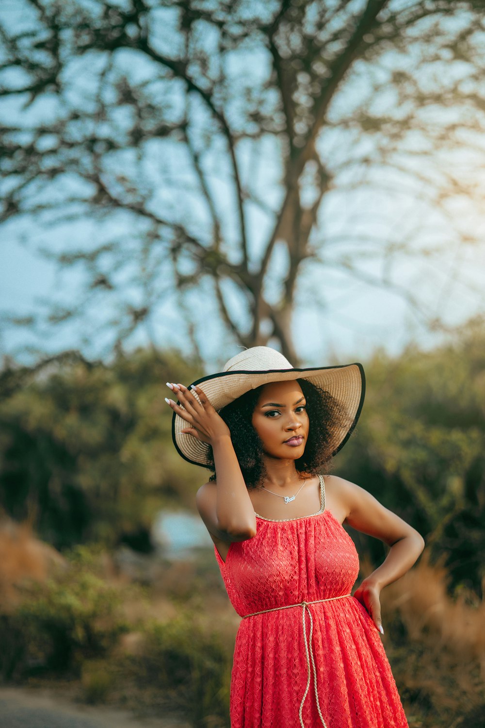 a woman in a red dress and a hat