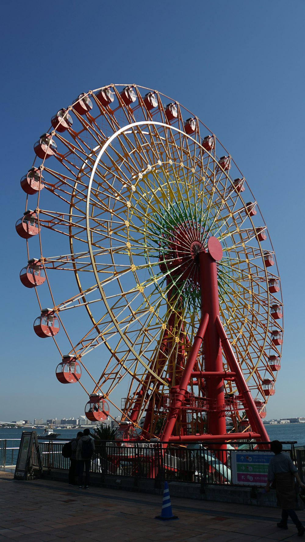 a large ferris wheel sitting next to a body of water