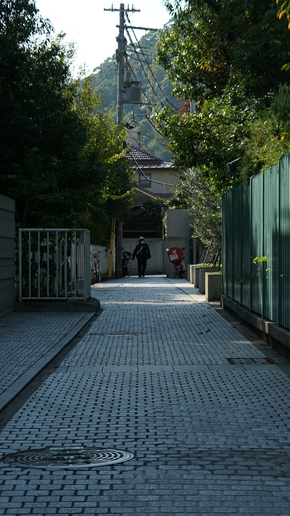 a person is walking down a brick road