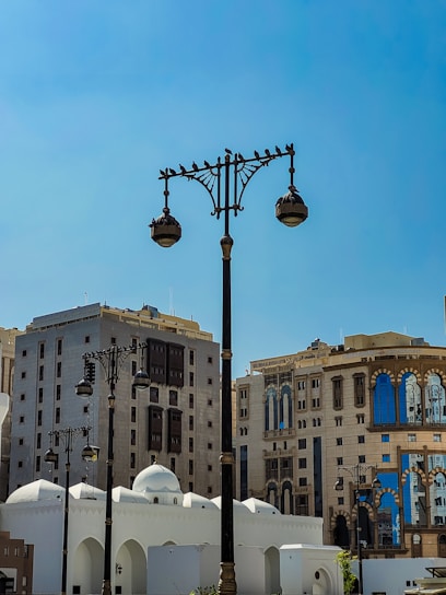 A vibrant street scene in Riyadh blending modern skyscrapers with traditional Arabian architecture under a clear blue sky.