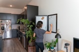 A cozy kitchen nook with a mother organizing family schedules on a whiteboard.
