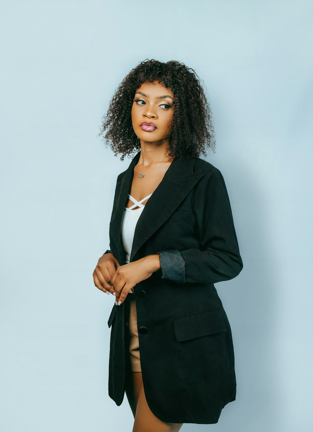 a woman in a black blazer posing for a picture