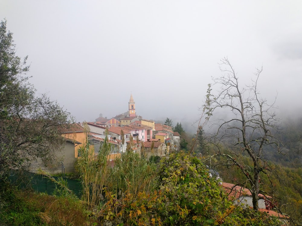 a village on a hill with a church in the background