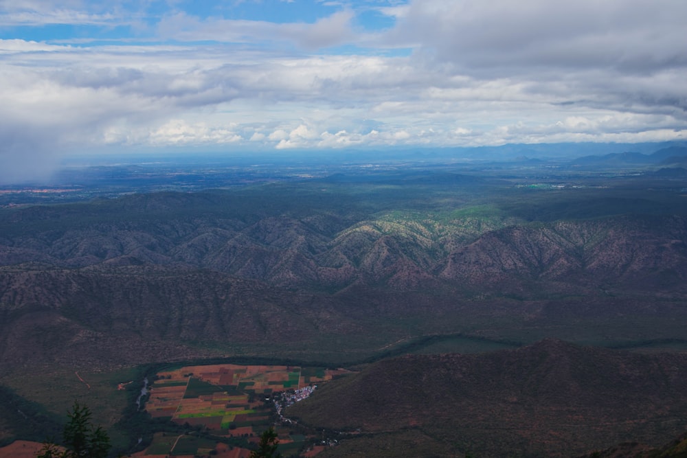 a view of a valley and mountains from an airplane