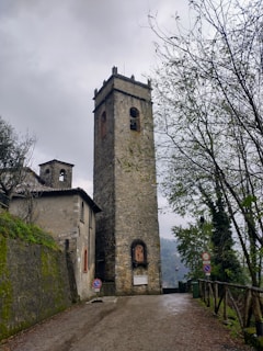 a tall tower sitting on the side of a road