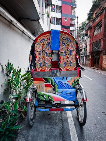 Close-up of a freshly painted SMV Wheels cycle rickshaw ready to hit the streets, symbolizing new beginnings.