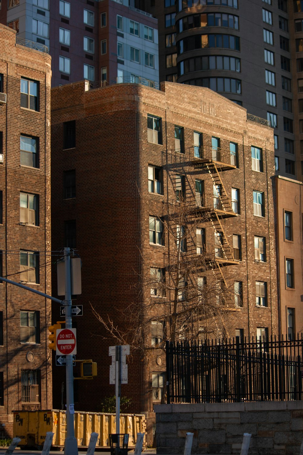 a tall brick building sitting next to a street
