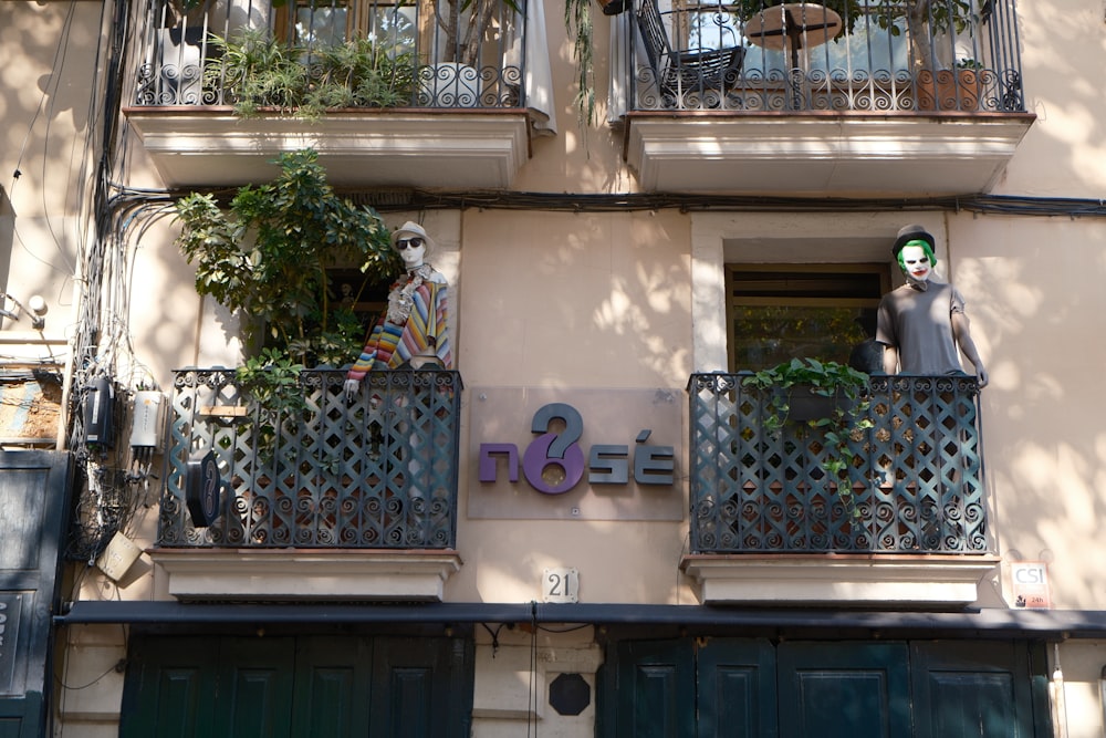 a building with a statue of a man on the balcony