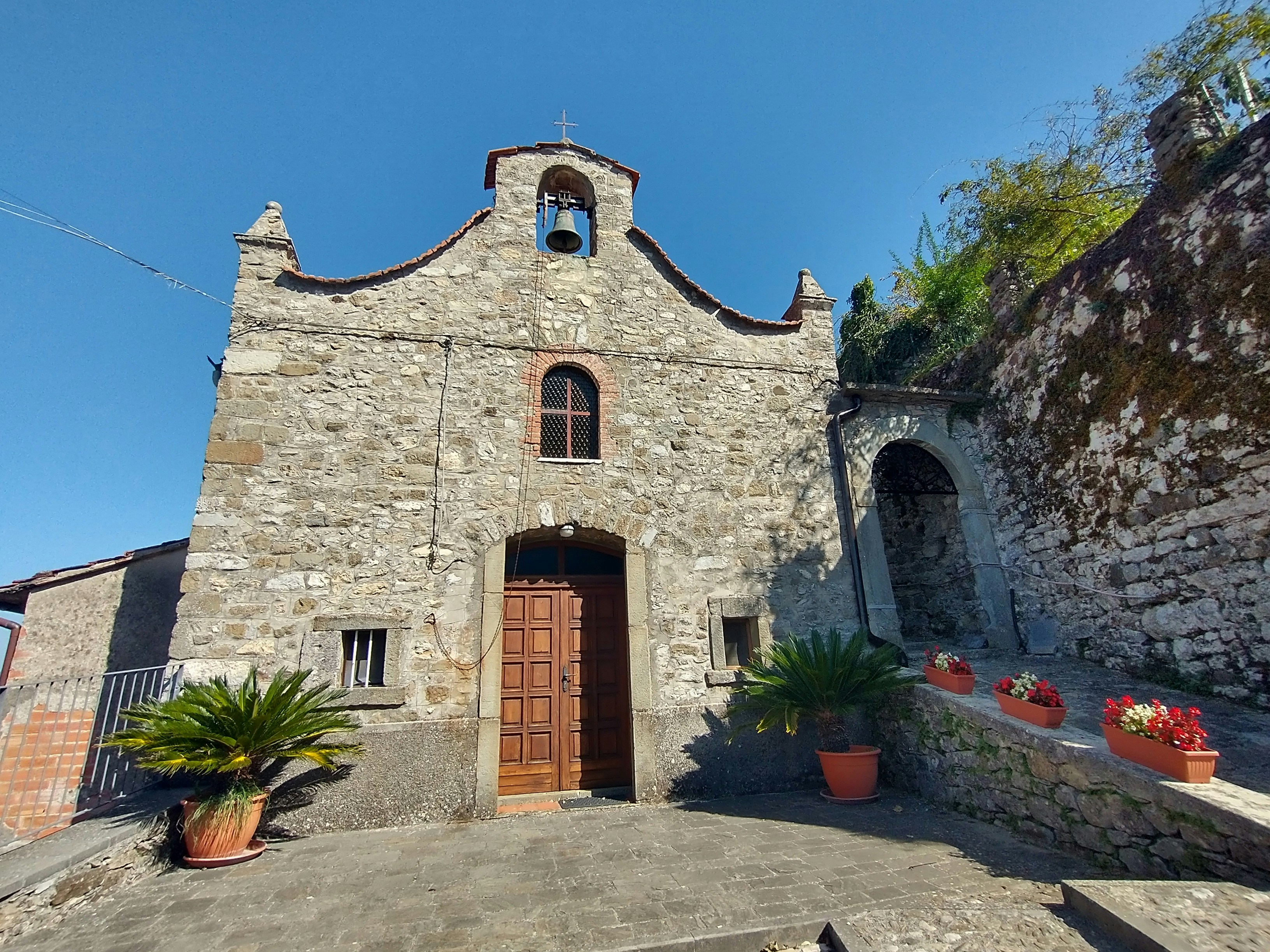 a stone building with a bell tower on top of it