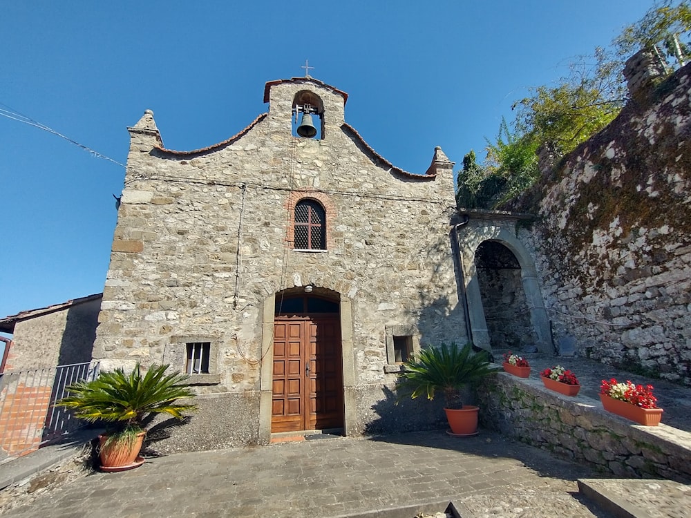 a stone building with a bell tower on top of it