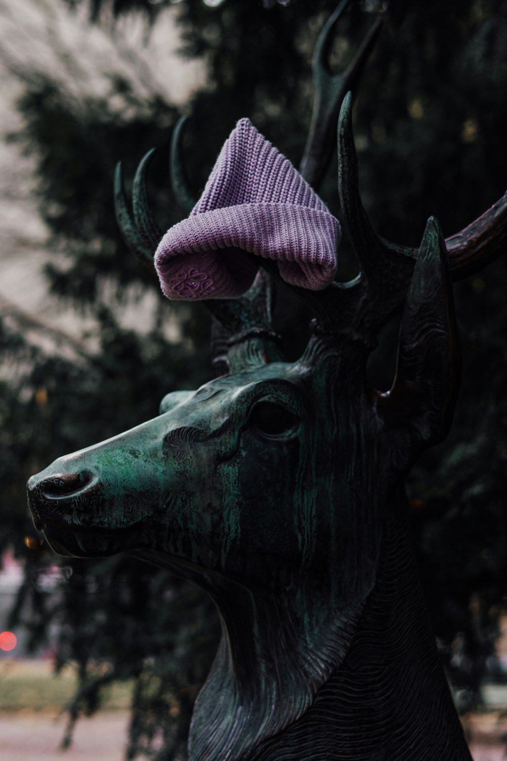 a statue of a deer with a hat on its head