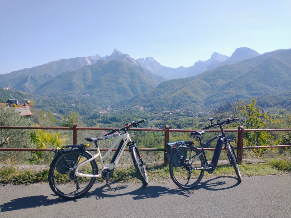 two bikes parked next to each other on a road