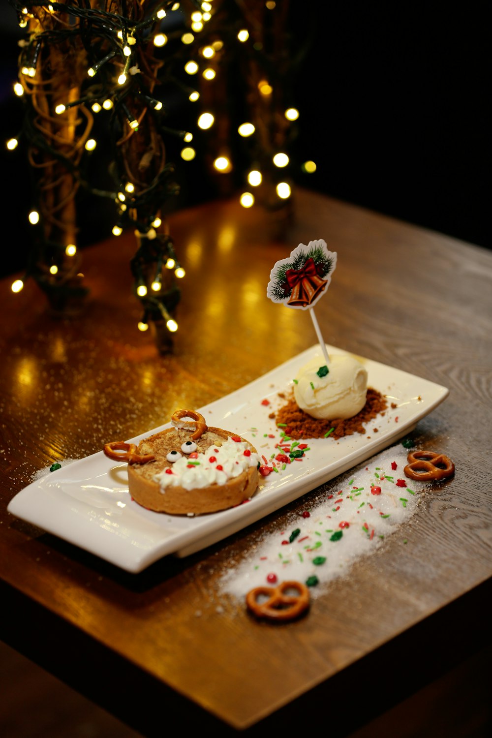 a plate of food on a table with a christmas tree in the background