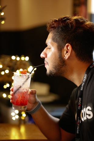 Evening ambiance showing a guest enjoying a refreshing drink in the lounge.