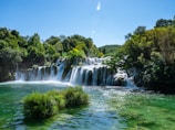 a large waterfall in the middle of a river