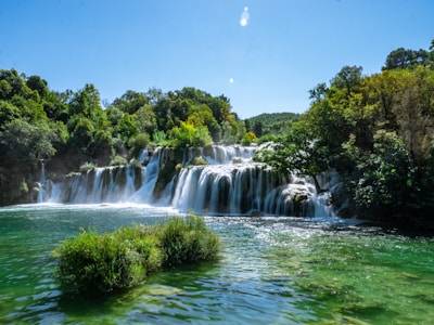 a large waterfall in the middle of a river