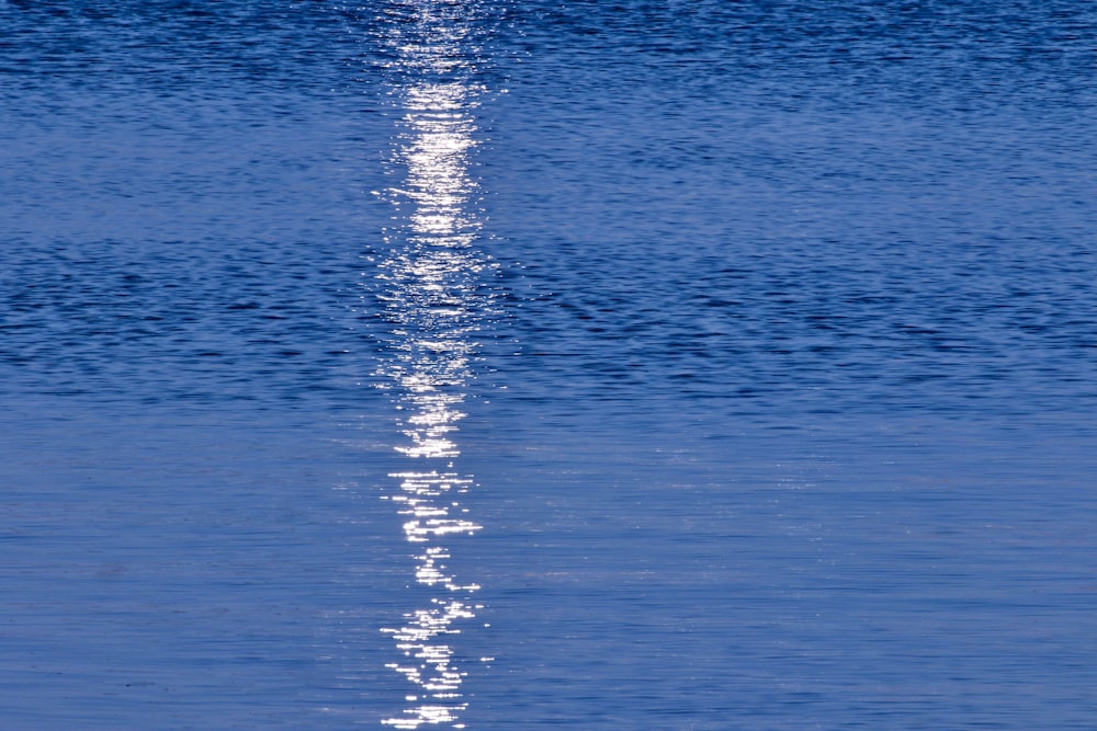 a long line of water with a boat in the distance