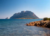 a large mountain in the middle of a body of water