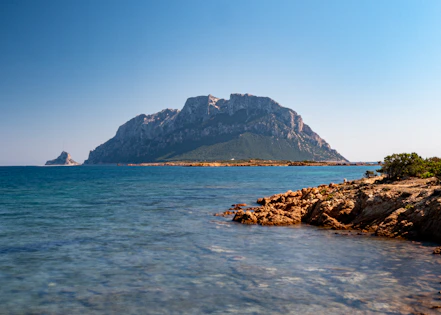 a large mountain in the middle of a body of water