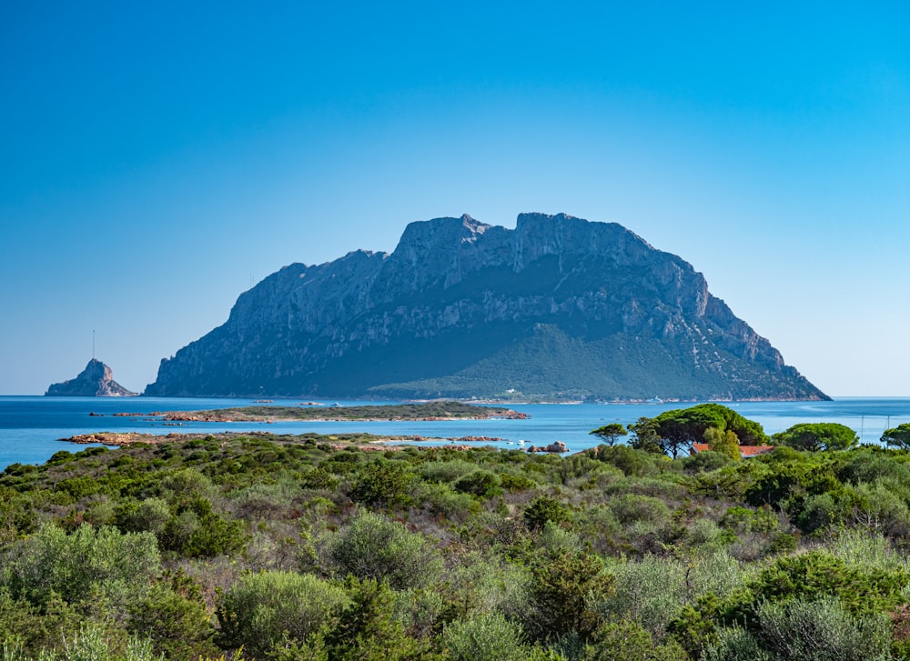 a mountain with a body of water in front of it