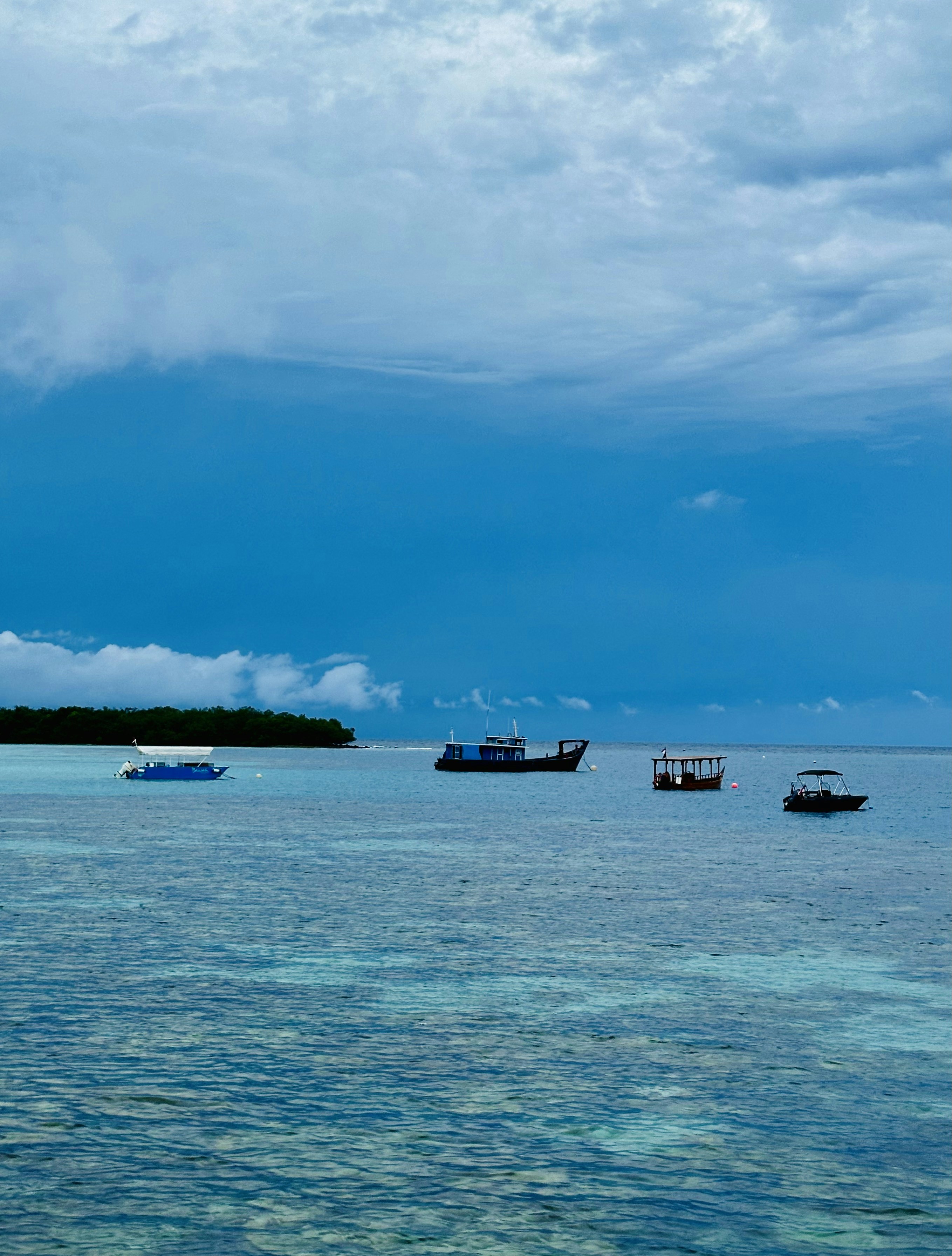 a group of boats floating on top of a large body of water