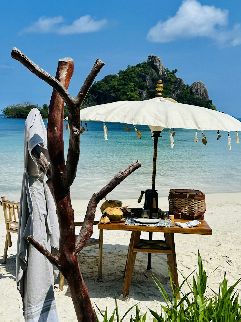 a table with an umbrella on a beach