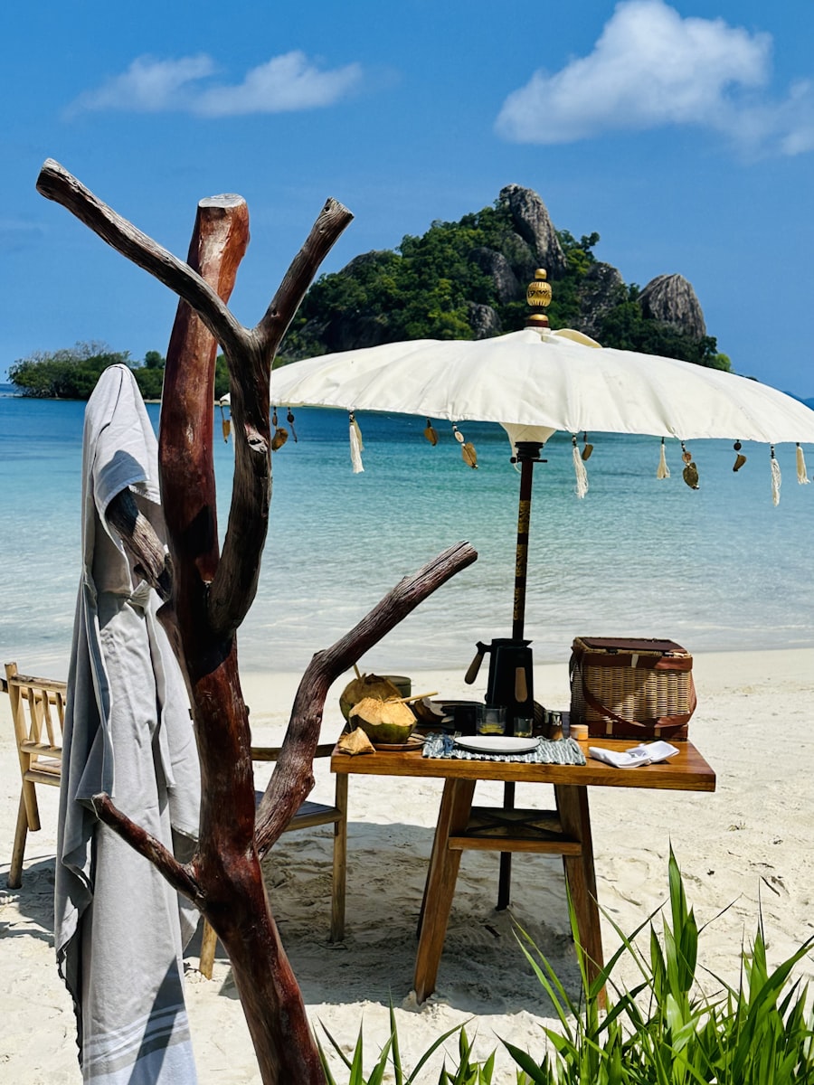 Shaded beach picnic setup on pristine white sand