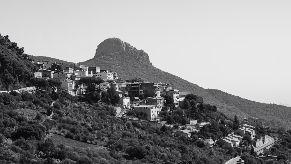 uma foto em preto e branco de uma aldeia em uma colina