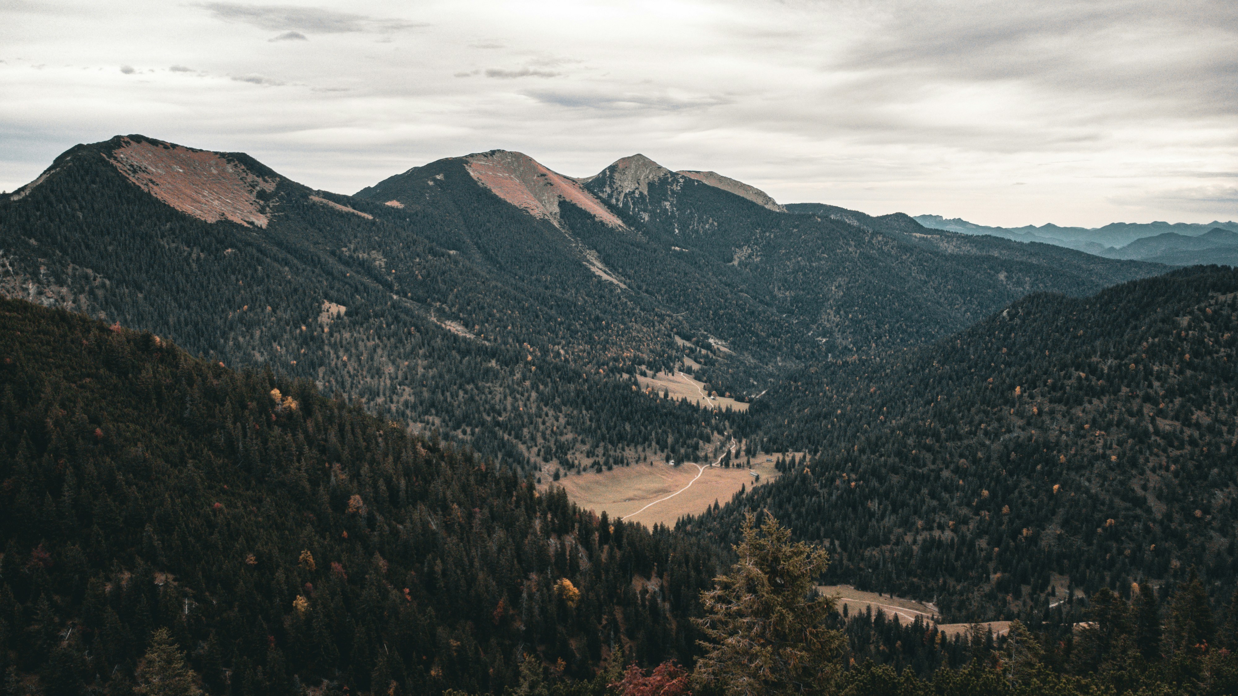 a scenic view of a valley surrounded by mountains