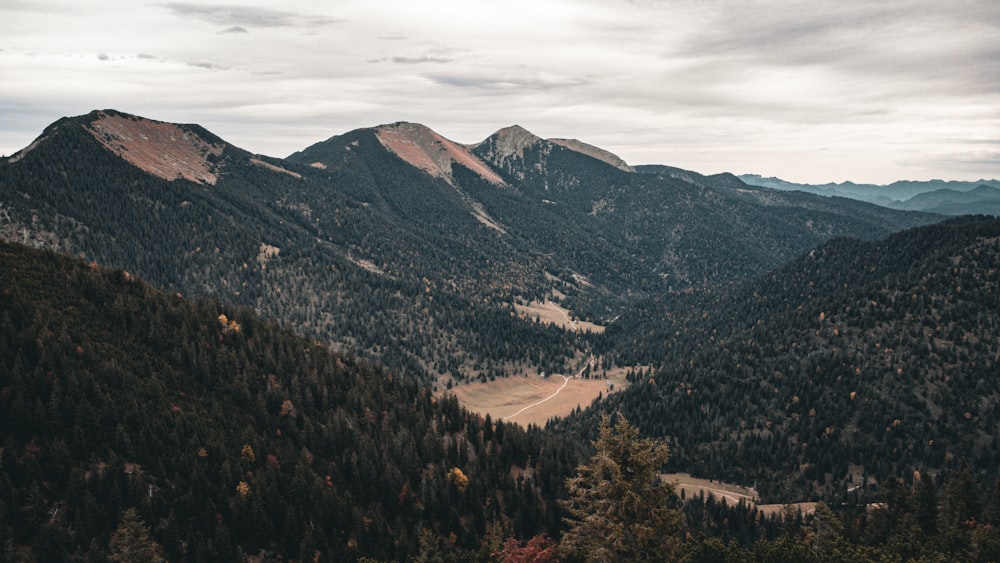 a scenic view of a valley surrounded by mountains