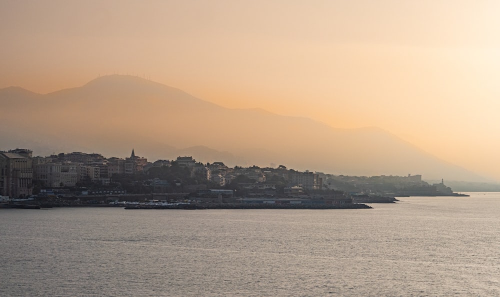 a large body of water with a city in the background