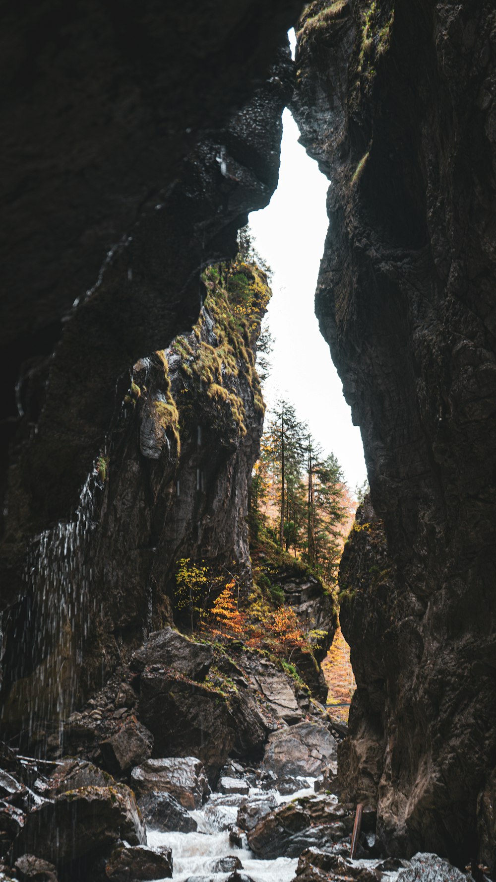 a river running through a cave filled with lots of rocks