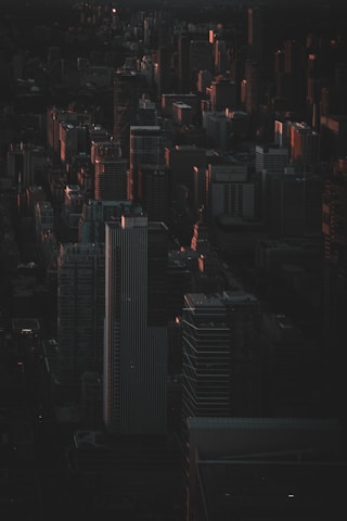 A cinematic frame of a cityscape at twilight with rich shadows and highlights, emphasizing composition.