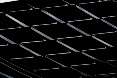 Close-up of a designer’s hand adjusting precise grid lines on a digital interface with dark luxury colors.