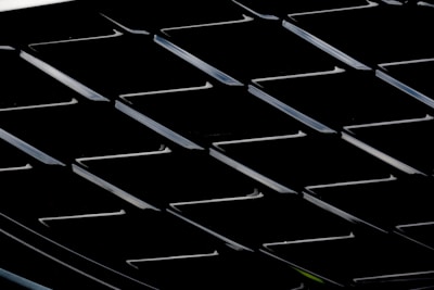 Close-up of a modern web design grid layout with red, black, and white color scheme in dark mode.