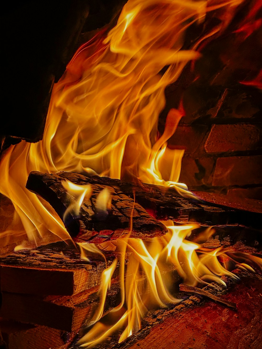 a fire burning in a fireplace with lots of flames