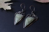 A set of handcrafted earrings made from repurposed vintage metal pieces.
