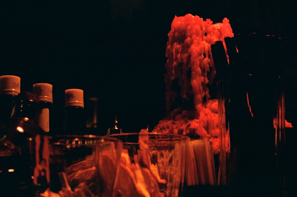 a table topped with glasses and bottles of liquid