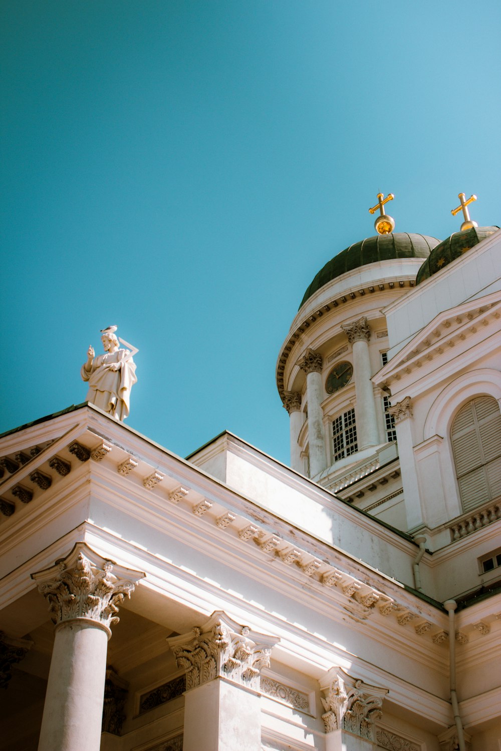 a white building with statues on top of it