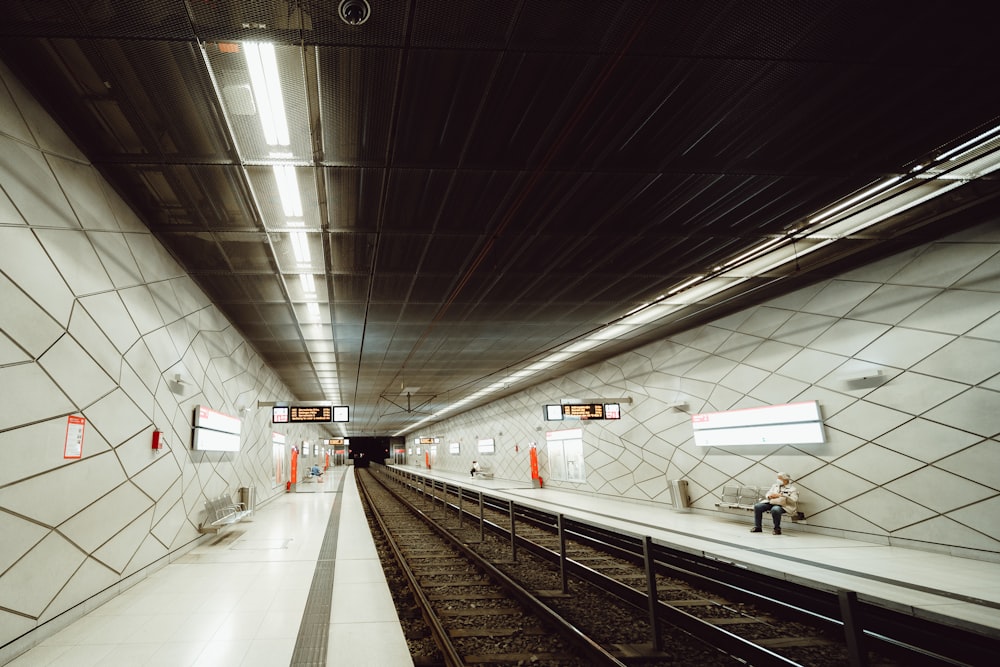 a train station with a train on the tracks