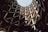 A spiral parking garage with curved concrete layers and geometric support structures, creating a pattern of light and shadow.