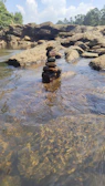 a stack of rocks sitting in the middle of a river