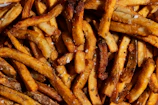 Close-up of golden, crispy french fries freshly dispensed from an Instafries vending machine.