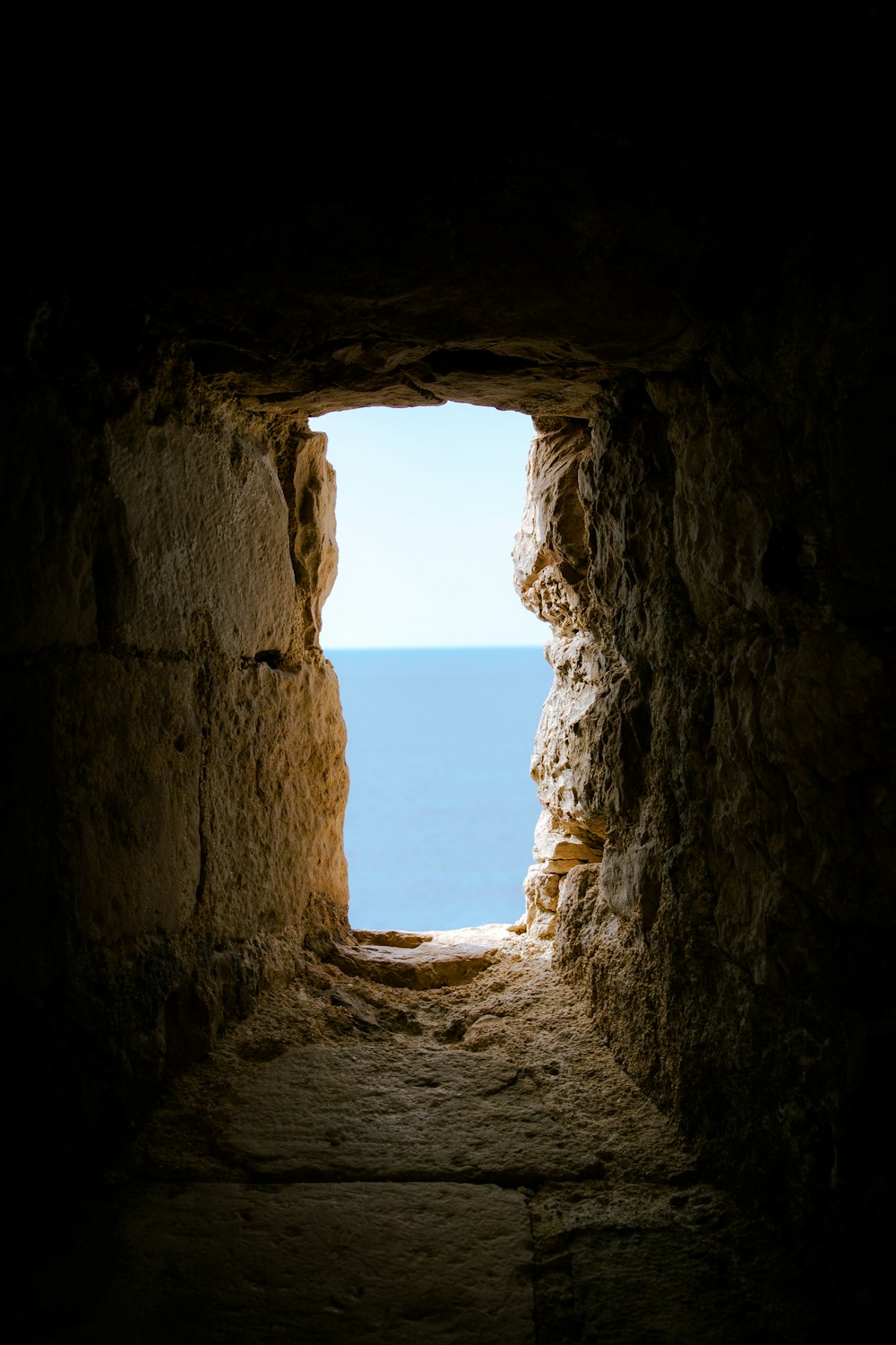 a view of the ocean from inside a cave